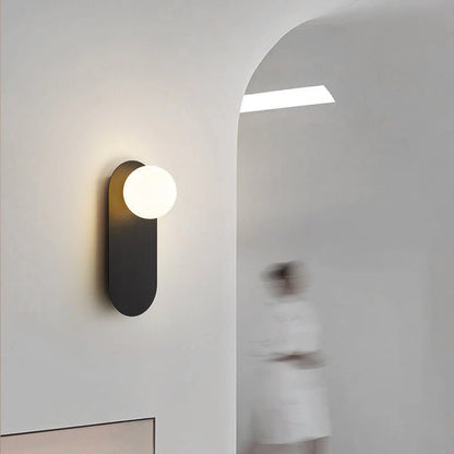 Minimalistyczna kinkietowa lampa ścienna z okrągłą szklaną podstawą